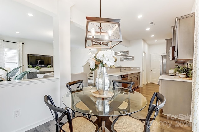 dining area with dark wood-type flooring and sink