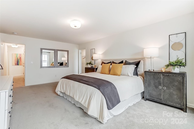 bedroom featuring light colored carpet and connected bathroom