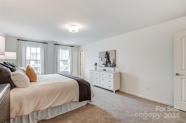 bedroom featuring light carpet