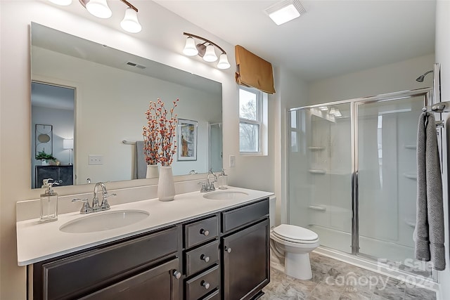 bathroom featuring vanity, toilet, and walk in shower