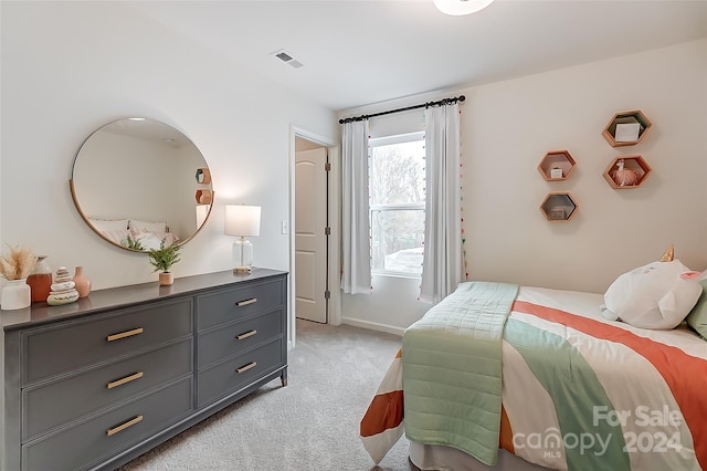 bedroom with light colored carpet