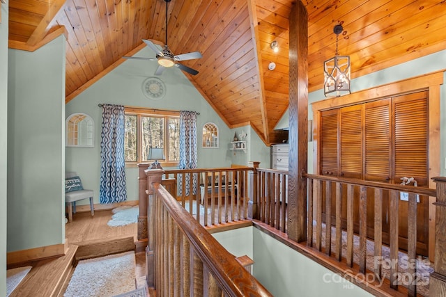 hall featuring light colored carpet, vaulted ceiling, wooden ceiling, and a notable chandelier