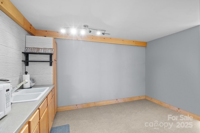 bathroom with sink and wooden walls