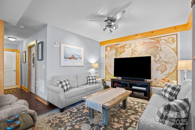 living room with ceiling fan and dark wood-type flooring