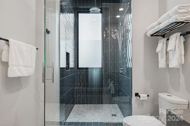 bathroom with toilet and walk in shower