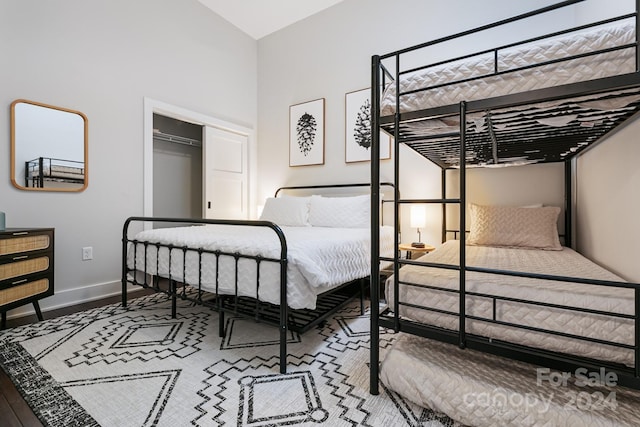 bedroom with hardwood / wood-style floors and a closet