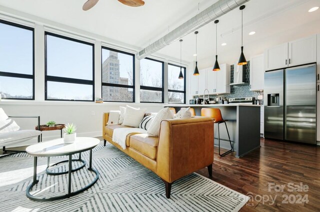 living room with ceiling fan and dark hardwood / wood-style floors