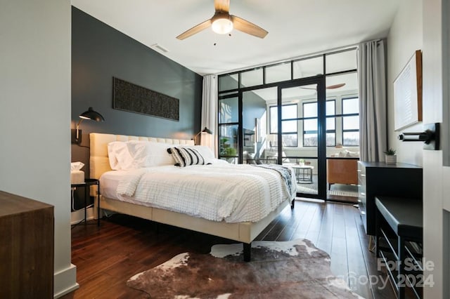 bedroom with access to exterior, ceiling fan, and dark wood-type flooring