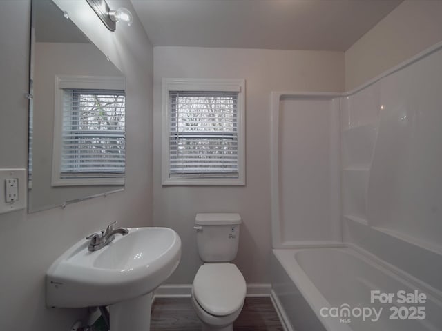 full bathroom with wood-type flooring, shower / tub combination, sink, and toilet