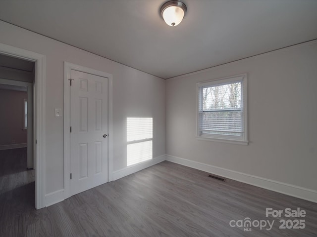 unfurnished bedroom with hardwood / wood-style floors