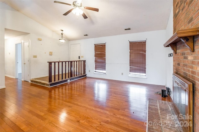 unfurnished living room featuring hardwood / wood-style flooring, ceiling fan, and lofted ceiling