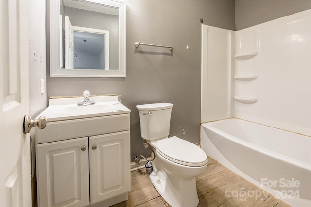 full bathroom featuring bathtub / shower combination, wood-type flooring, vanity, and toilet