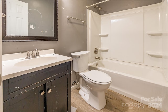 full bathroom with hardwood / wood-style floors, vanity, toilet, and bathing tub / shower combination