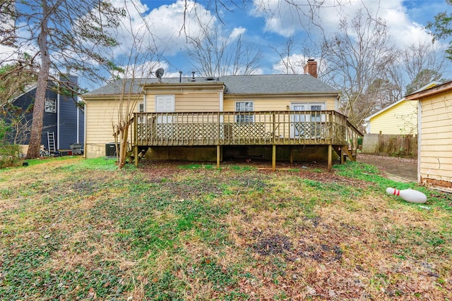 back of house featuring a yard, central AC, and a wooden deck