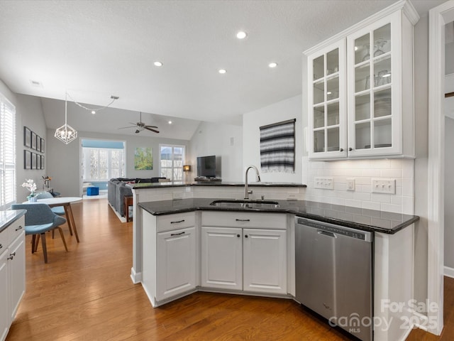 kitchen featuring white cabinets, tasteful backsplash, stainless steel dishwasher, and sink