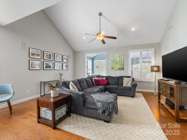 living room with high vaulted ceiling, light hardwood / wood-style flooring, and ceiling fan