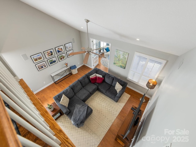 living room featuring wood-type flooring and vaulted ceiling