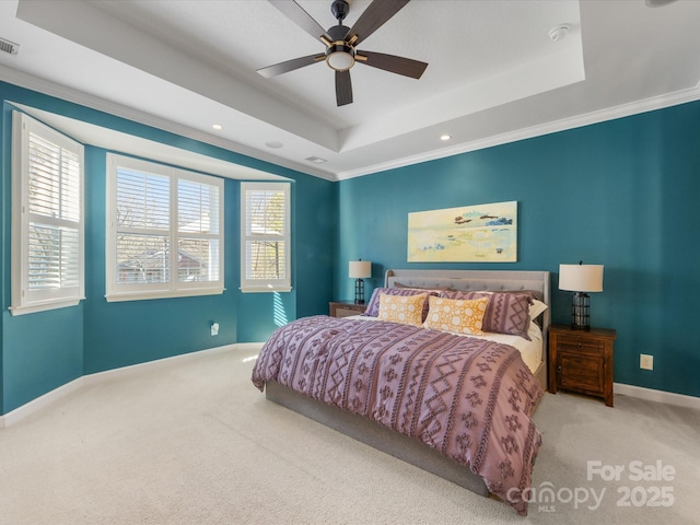 carpeted bedroom with ceiling fan, a raised ceiling, and ornamental molding