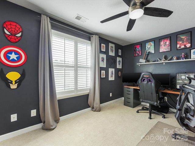 carpeted office space with ceiling fan