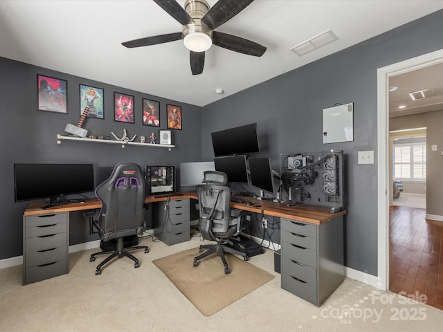 office space featuring light carpet and ceiling fan