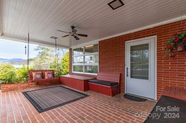 view of patio / terrace featuring ceiling fan and a mountain view