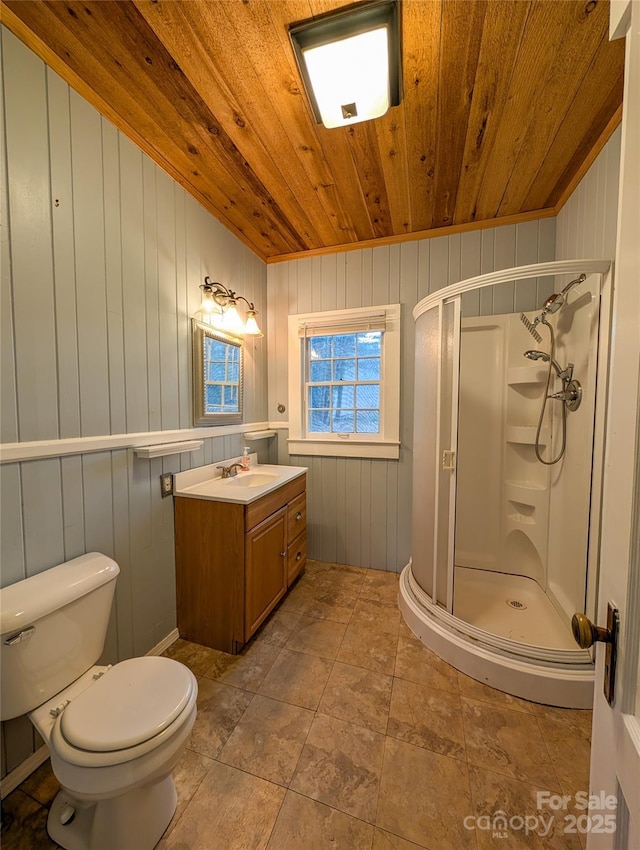 bathroom featuring toilet, a stall shower, wood ceiling, and vanity