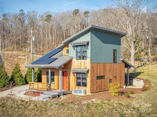 view of front of property with solar panels and covered porch