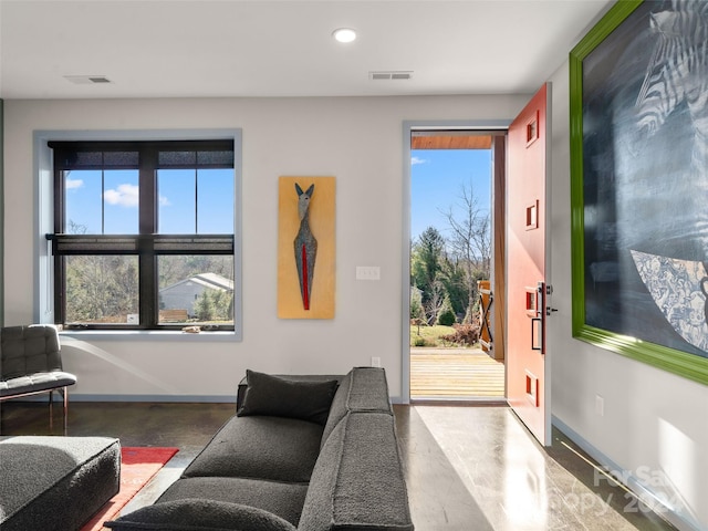 interior space featuring plenty of natural light and concrete flooring