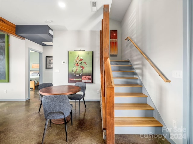 stairway featuring concrete flooring