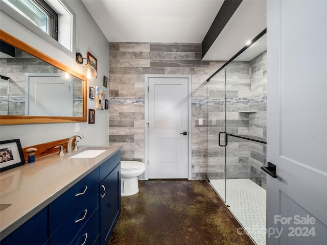 bathroom featuring vanity, toilet, tile walls, walk in shower, and concrete floors