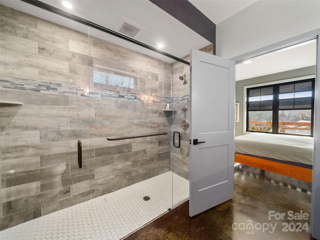 bathroom with an enclosed shower and concrete floors