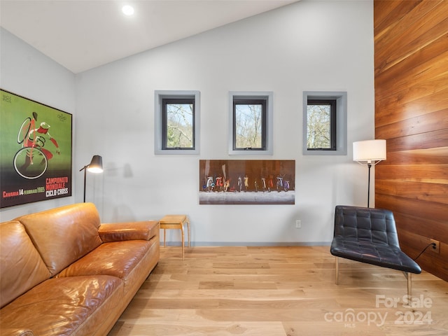 living room featuring light hardwood / wood-style flooring and vaulted ceiling