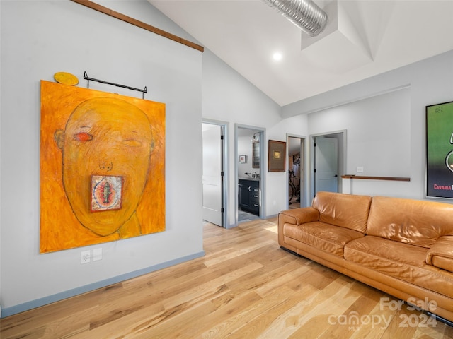 unfurnished living room with light hardwood / wood-style floors and high vaulted ceiling