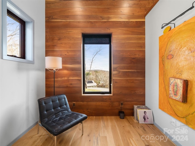 sitting room with light wood-type flooring and wood ceiling