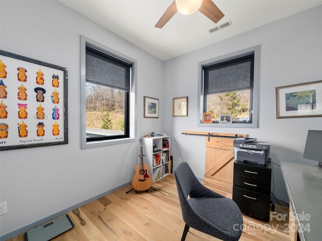 office space with light wood-type flooring and ceiling fan