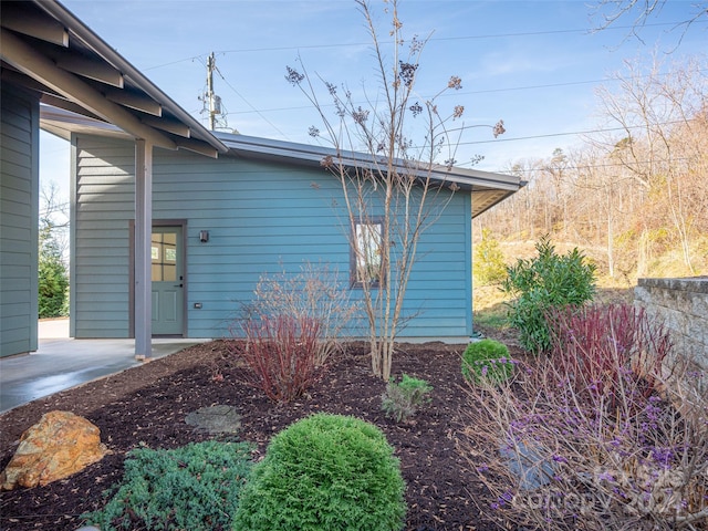 view of side of home with a patio area