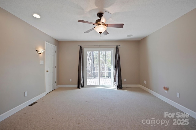 empty room with light carpet, a textured ceiling, and ceiling fan