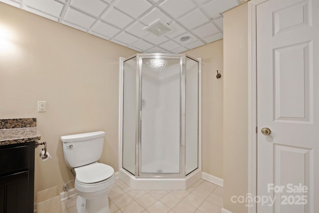 bathroom with vanity, toilet, tile patterned floors, and walk in shower