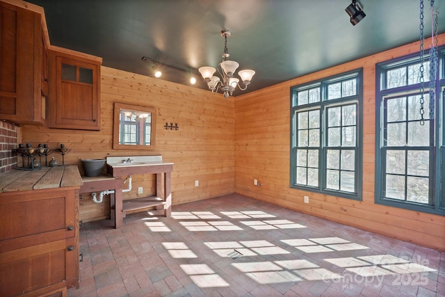 office space featuring a healthy amount of sunlight and wood walls