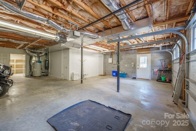 basement featuring electric panel and electric water heater