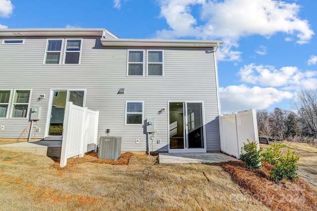 back of property featuring central AC unit and a patio