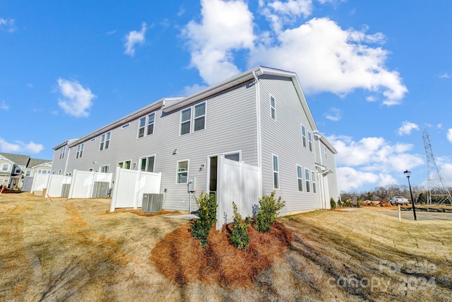 back of house with central AC