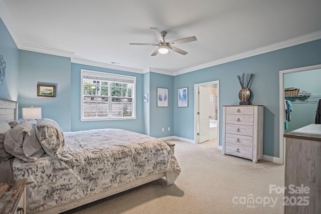 bedroom featuring light carpet, a walk in closet, ceiling fan, connected bathroom, and a closet