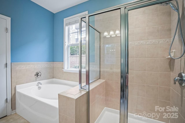 bathroom featuring tile patterned flooring and plus walk in shower