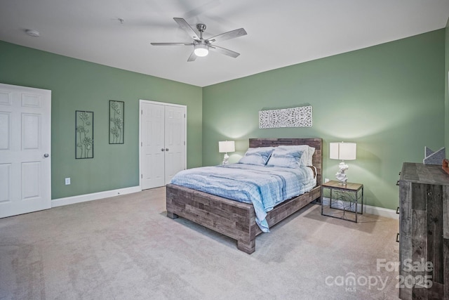 carpeted bedroom with ceiling fan and a closet