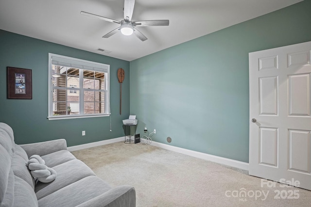 sitting room featuring ceiling fan and light colored carpet