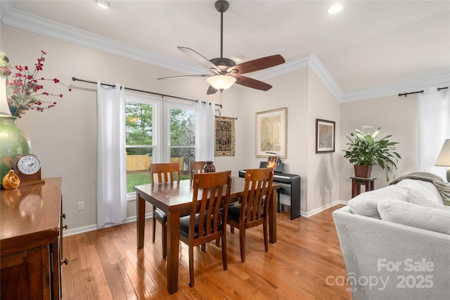 dining area with crown molding, ceiling fan, and light wood-type flooring