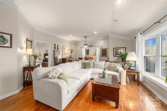 living room with light hardwood / wood-style flooring, ceiling fan, and a healthy amount of sunlight