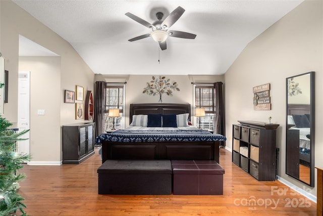 bedroom featuring wood-type flooring, ceiling fan, and lofted ceiling