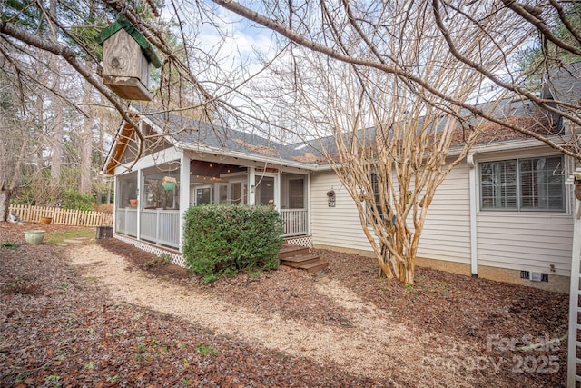 back of house featuring a sunroom